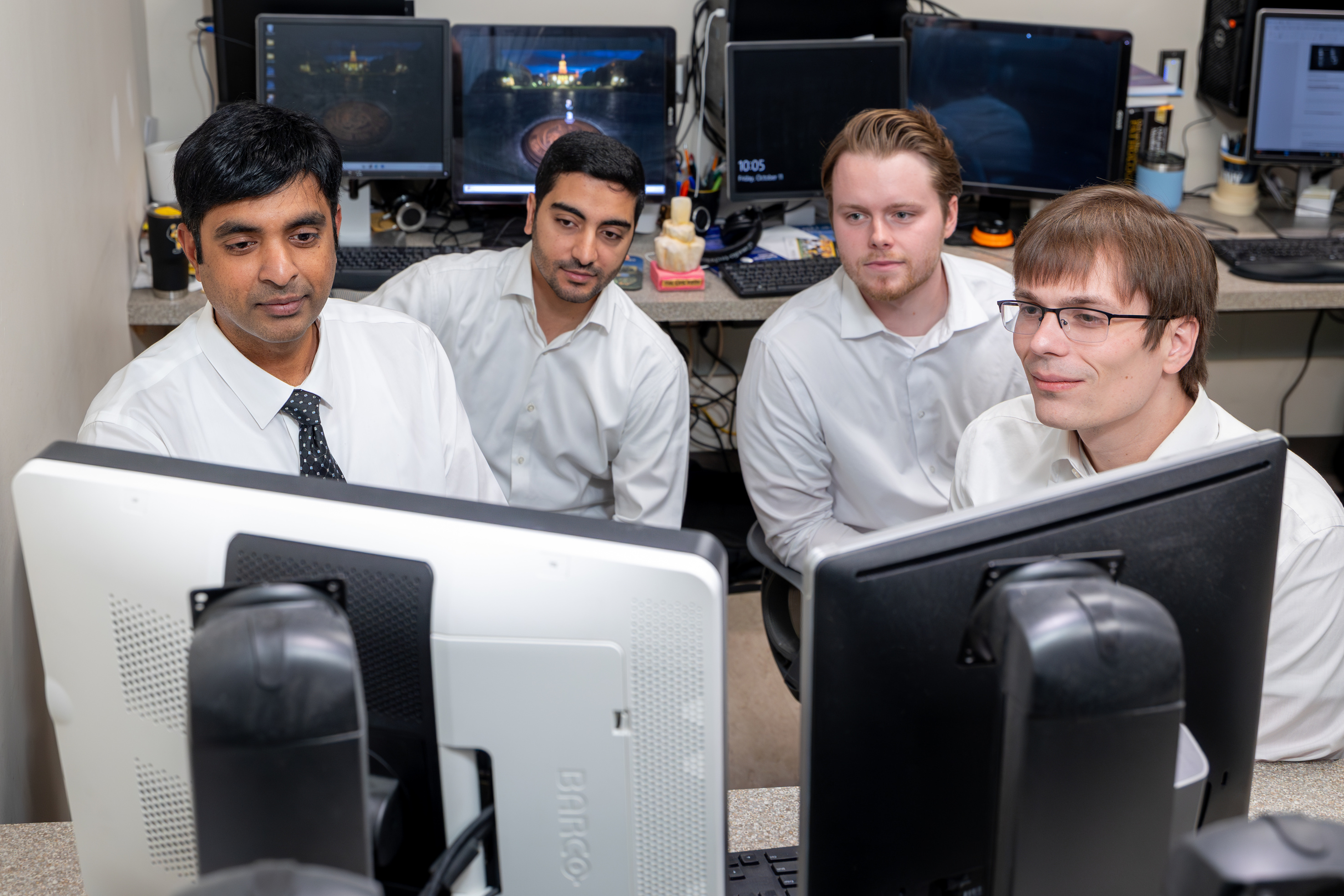 Dr.  Allareddy works with members of the Oral Pathology, Radiology, and Medicine Advanced Education Program. From left to right: Dr. Allareddy, Menthen Abdulrahim, Justin Martin, and Austin Hughes.