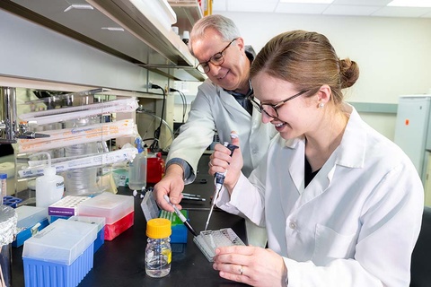 Professor Jeff Banas conducting research with  a dental student small.jpg
