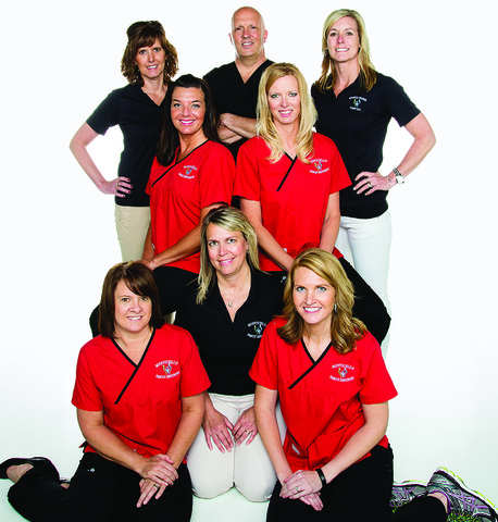 Brian James poses for a photo with his staff at his Monticello private practice.