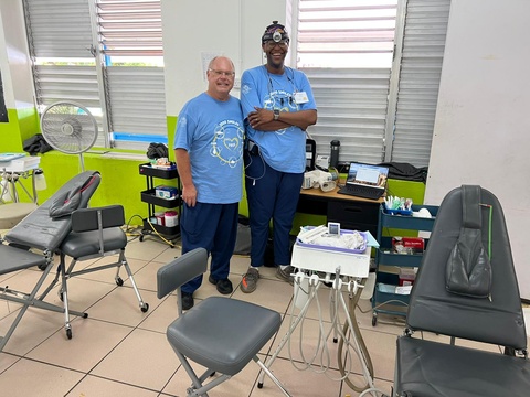 Justman posing for a photo with a fellow volunteers in St. Lucia.