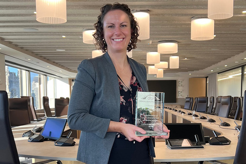 Dr. Julie Reynolds poses with a plaque commemorating her service as the Chair of the Dental Quality Alliance at the American Dental Association Headquarters in Chicago.