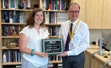 Emily Starman receiving award from Clark Stanford
