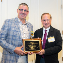 Dean Stanford and Zach Kouri pose for a photo after Kouri was presented the 2024 Dental Service Recognition Awardee