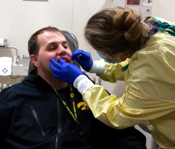 A UI REACH student receiving one-on-on toothbrushing instruction