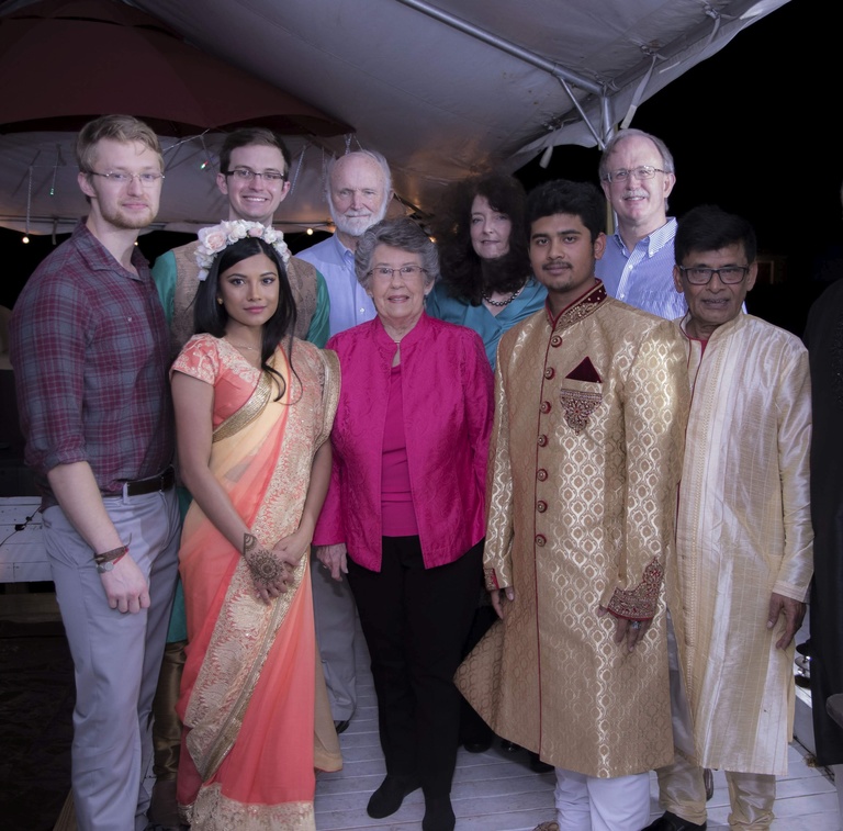 Zina Mangleburg's support system is her family and her husband's family. Here is a photo of all of us during our gaye holud-which is a ceremony observed in Bangladesh and other south Asian countries before weddings. She is wearing a pink Sari, and her husband is behind her wearing teal and gold.