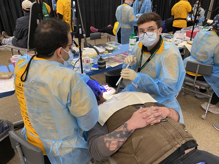 Dental providers giving care at IMOM 2023
