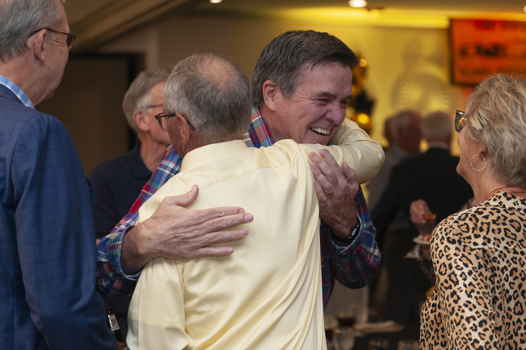 John Arend hugs an old friend at the 2023 Alumni Reunion at the Radisson Hotel.