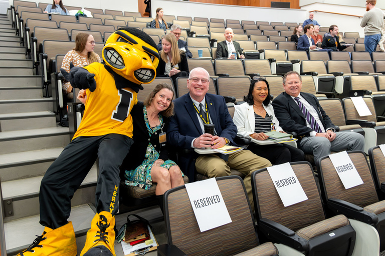 Herky posing with a few of the college's deans
