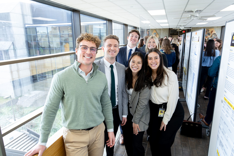 Students pose for a photo on the fourth floor of the DSB during the 2024 AADOCR Research Day.