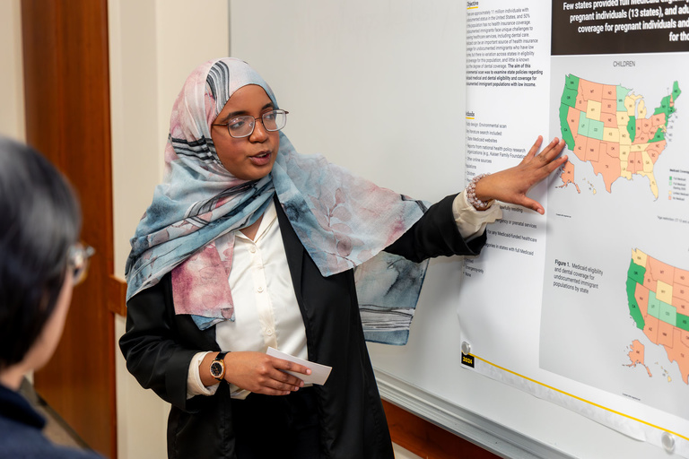 A presenter explains her research during the 2024 AADOCR Research Day