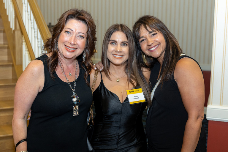 Three alumni pose for a picture at the 2024 Alumni Reception at The Graduate Hotel.