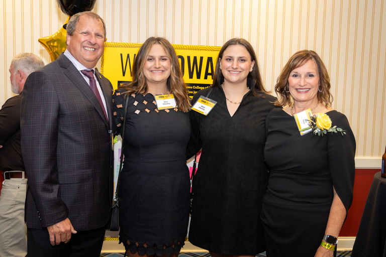 2024 Alumnus of the Year Lisa Holst takes a picture with her family.