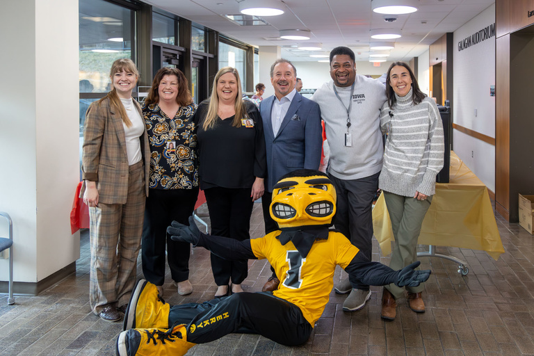 Faculty and staff pose with Herky before research day beings