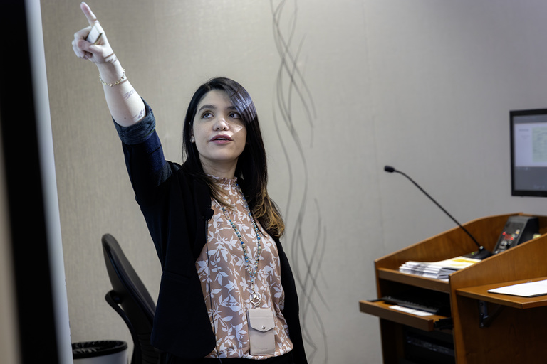 A presenter points to a board during oral presentations during research day on Feb. 11, 2025