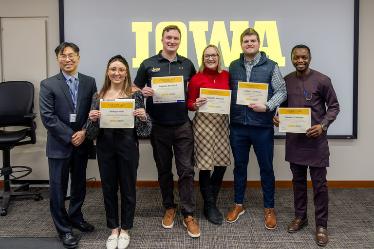 Orthodontic residents pose for a photo with their certificates of presentation.