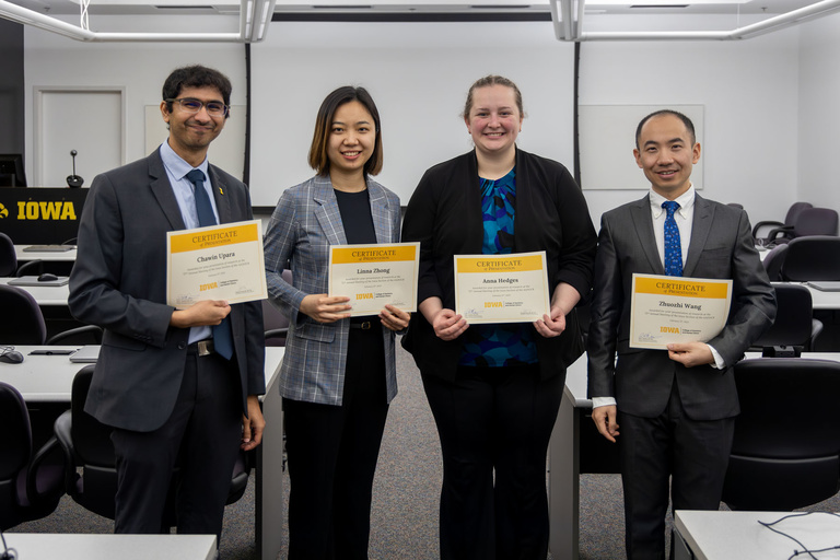 Students pose for a photo with their Certificates of Presentation.