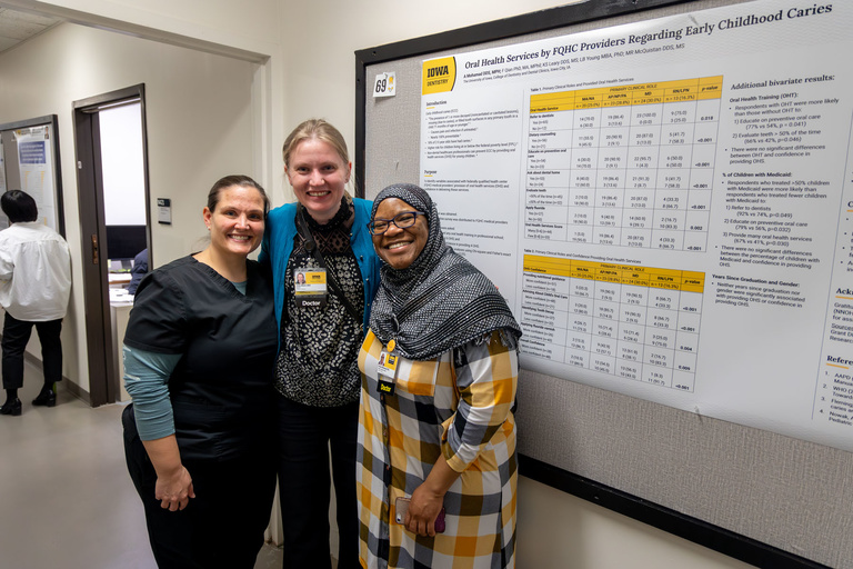 Researchers pose for a picture during poster presentations during research day.