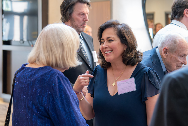 Dr. Hernandez converses during the OKU reception.