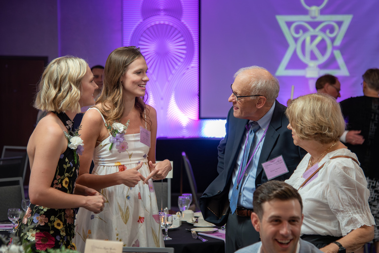 Members of OKU catch up before the start of the 2025 OKU Reception.