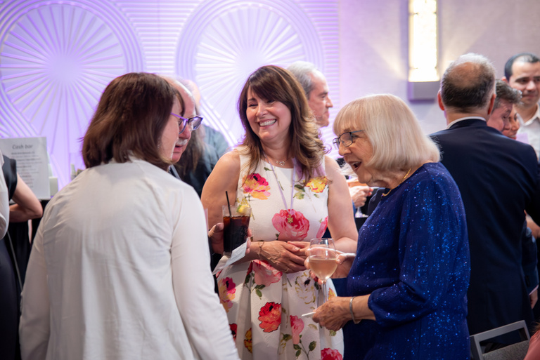 Members of OKU catch up prior to the reception.