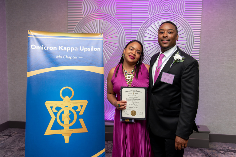 Austen Hawthorne poses for a picture with his spouse after being named the 2025 Honorary OKU Awardee