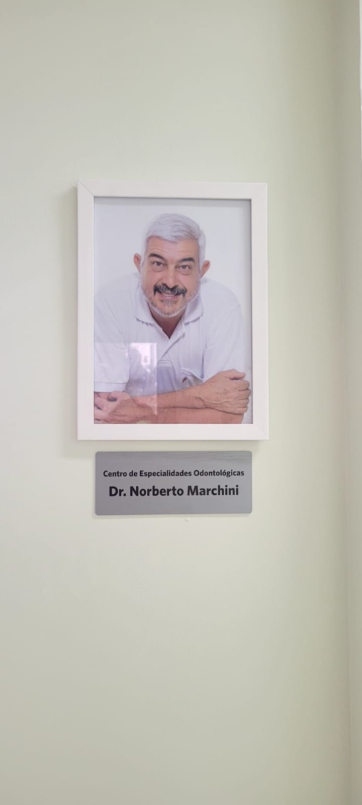 A plaque in honor of Dr. Noberto Marchini located in the new dental clinic in Brazil