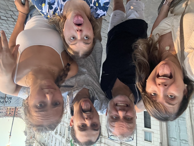 Karin, Nathalia, and the rest of their family take a goofy group photo while on vacation.