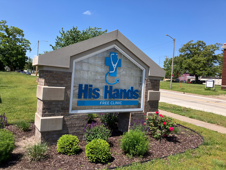 A picture of the His Hands sign in front of the clinic.