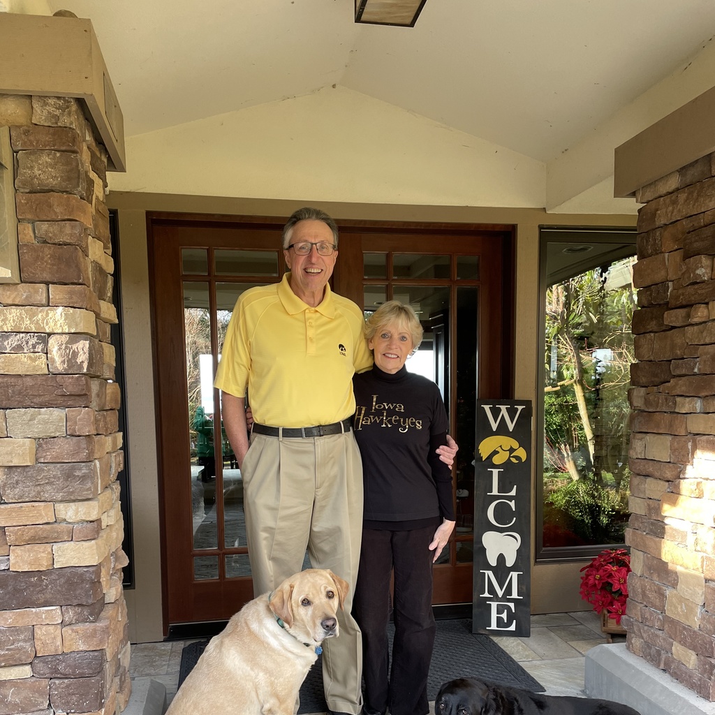 Bob and Jerilee Williams at their front door with their dogs