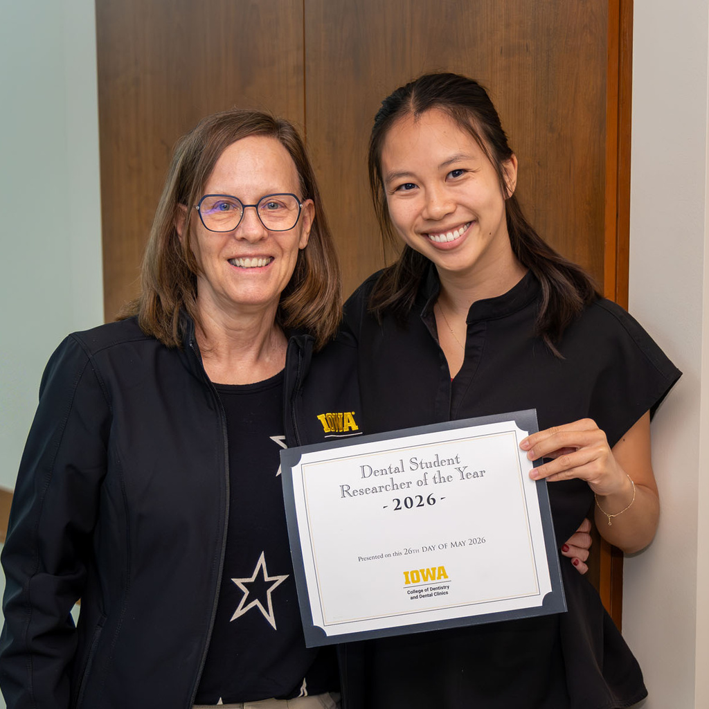 Vi Phan receiving the 2026 Student Researcher of the Year from Dr. Marshall
