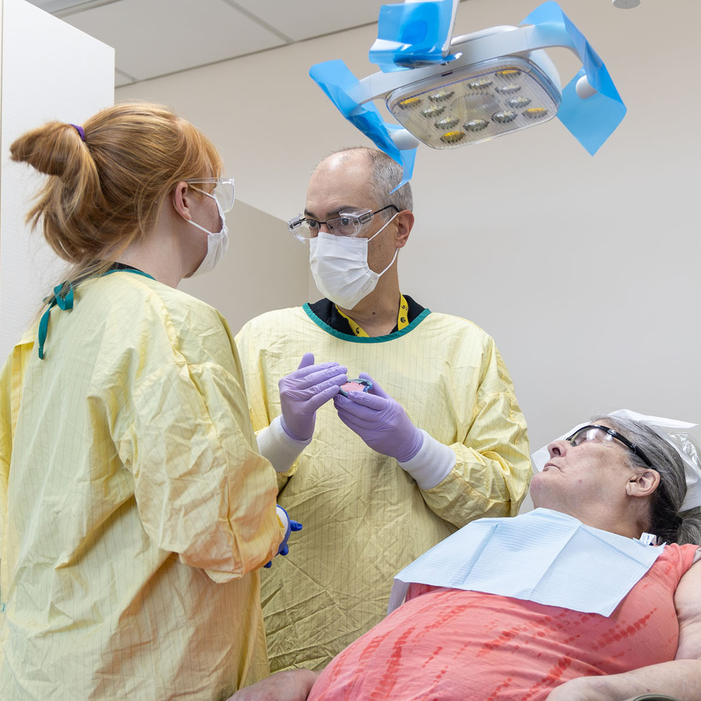 Leo Marchini instructs a dental student in the GSN clinic.