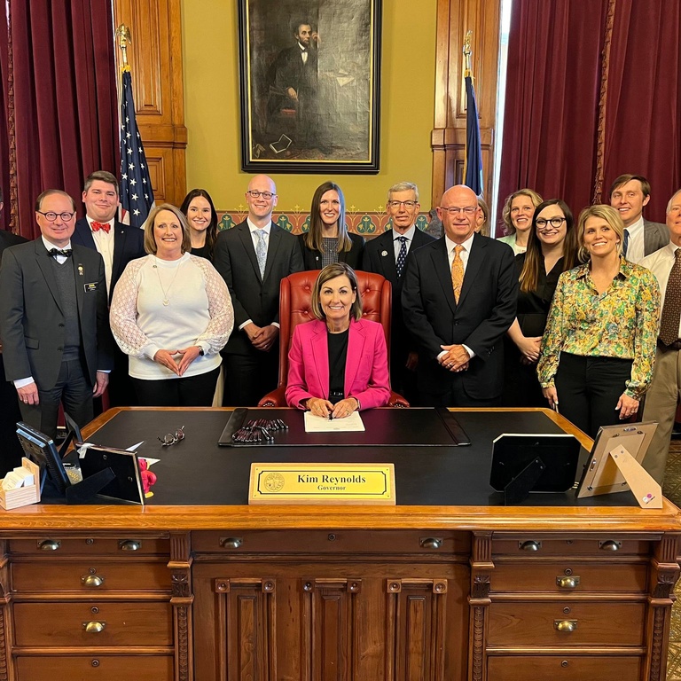 Iowa dentistry leaders with Governor Kim Reynolds at a bill signing