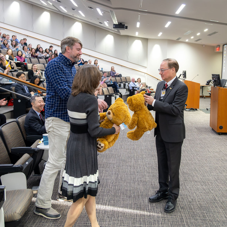 Dean Stanford continues his tradition of presenting teddy bears to faculty and staff as a symbol of their hard work and determination to achieving success.