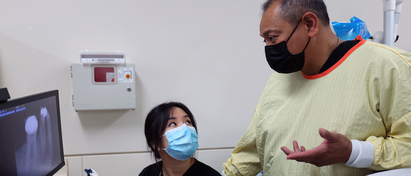 Salvador Atienza teaching a student in the Family Dentistry clinic