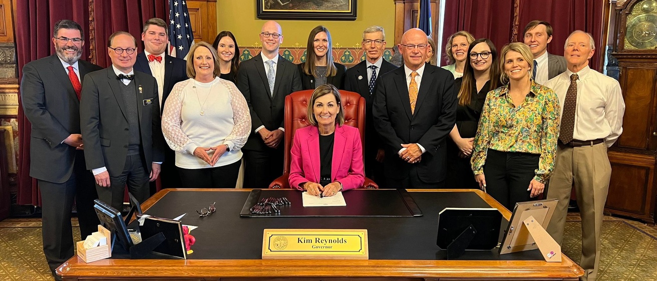 Iowa dentistry leaders with Governor Kim Reynolds at a bill signing