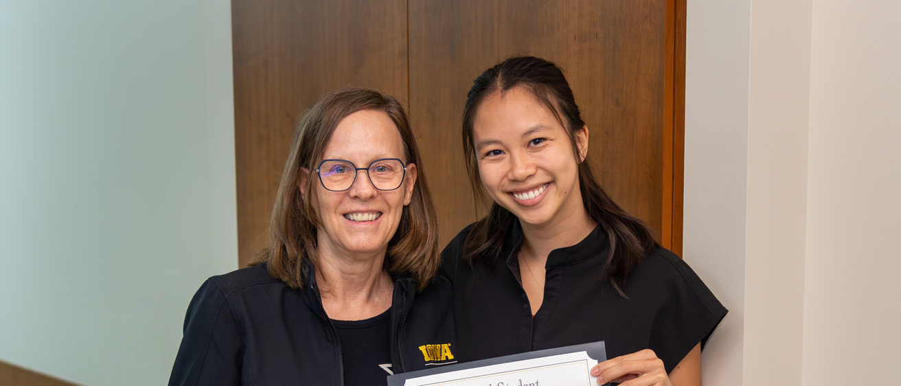 Vi Phan receiving the 2026 Student Researcher of the Year from Dr. Marshall