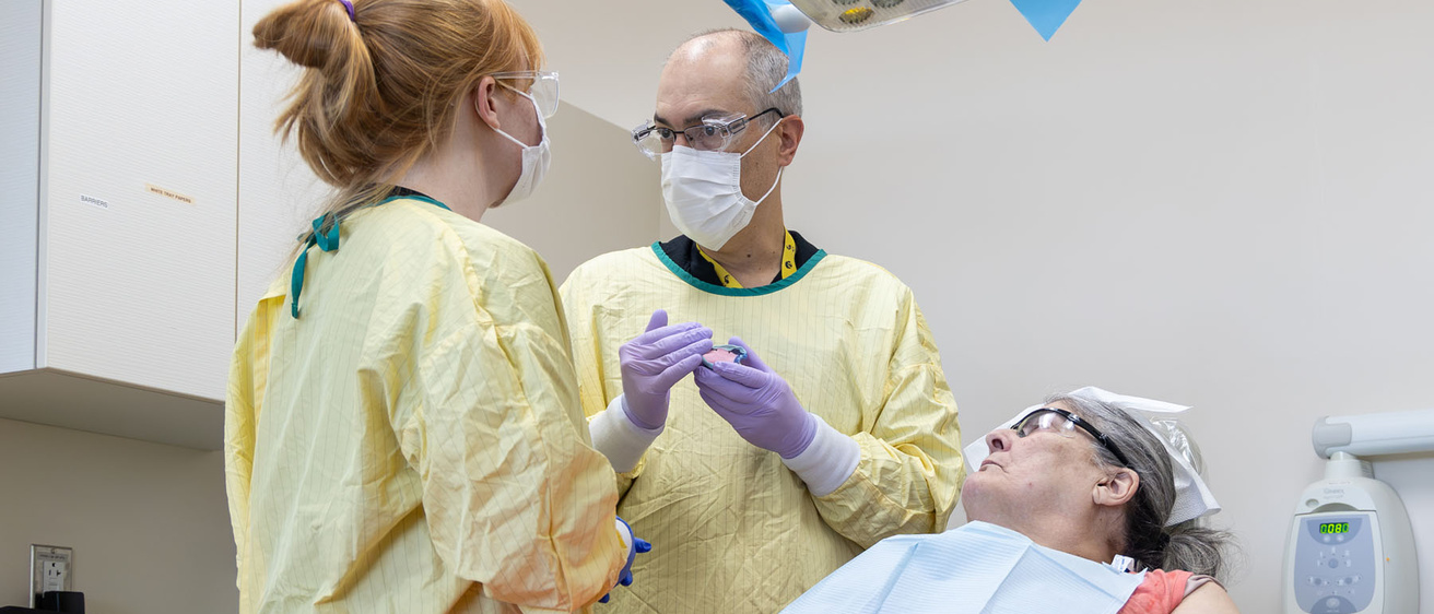 Leo Marchini instructs a dental student in the GSN clinic.