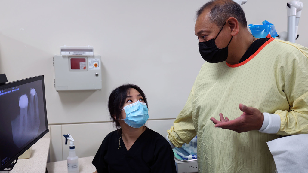 Salvador Atienza teaching a student in the Family Dentistry clinic