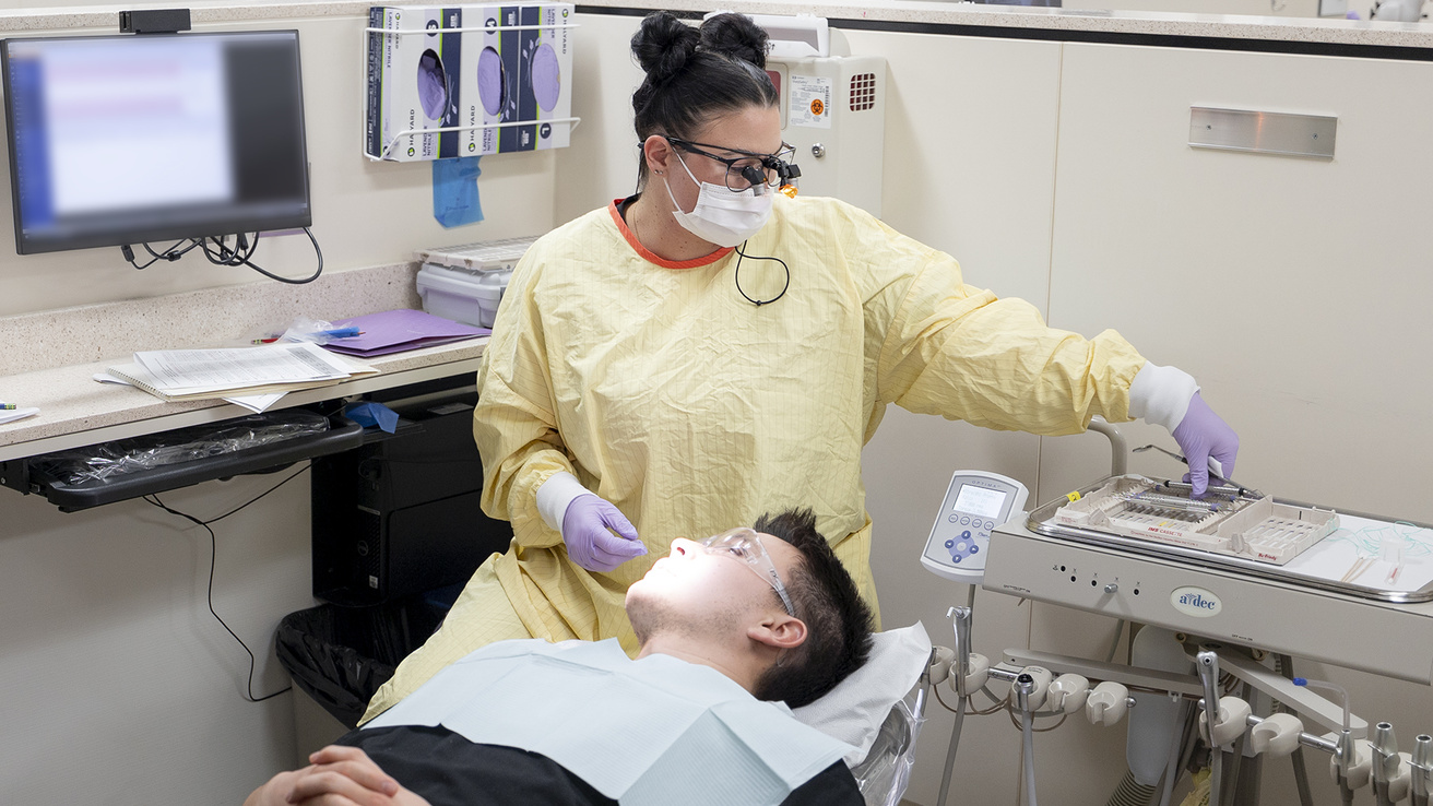 Dental student providing peer to peer oral health care