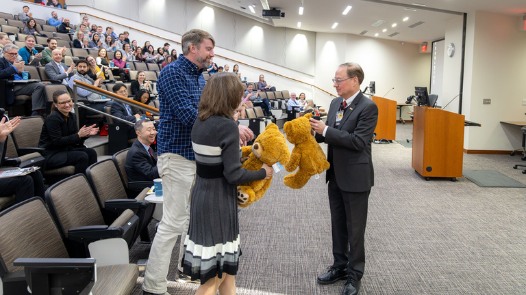 Dean Stanford continues his tradition of presenting teddy bears to faculty and staff as a symbol of their hard work and determination to achieving success.